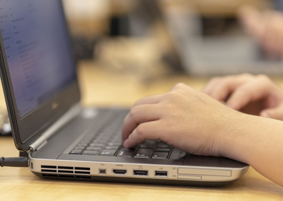 closeup of hands on a laptop keyboard