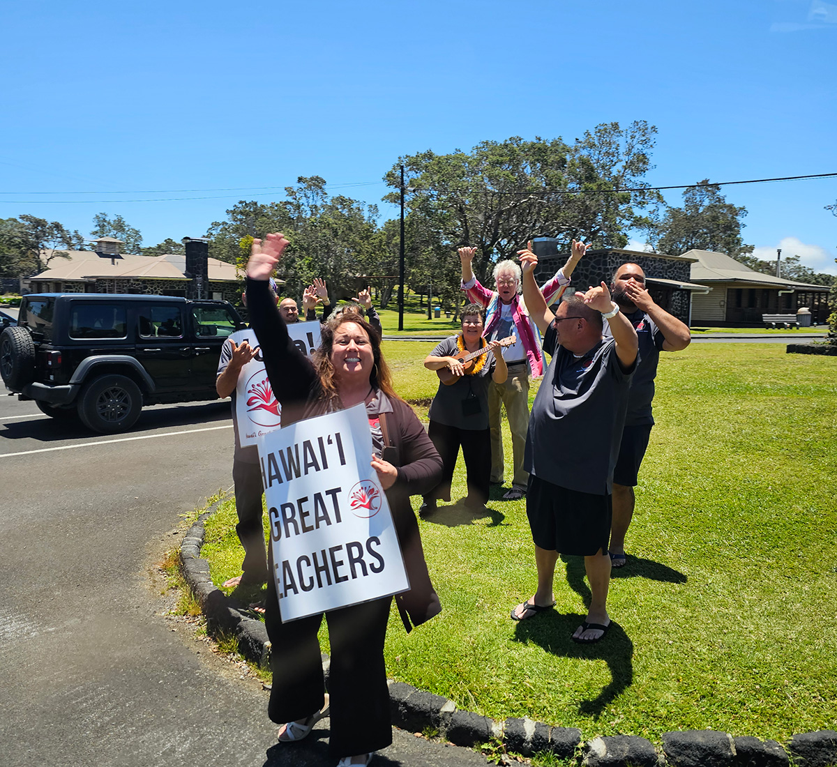 Hawaii Great Teachers group waving signs